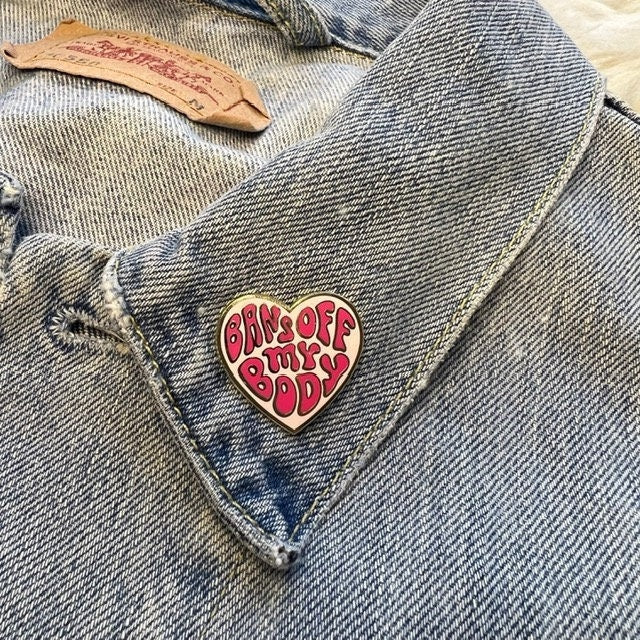 AC00374-MLT-OS - Bans Off My Body Heart Pin - Planned Parenthood Social Justice Heart Pins - Wildflower + Co on jacket collar