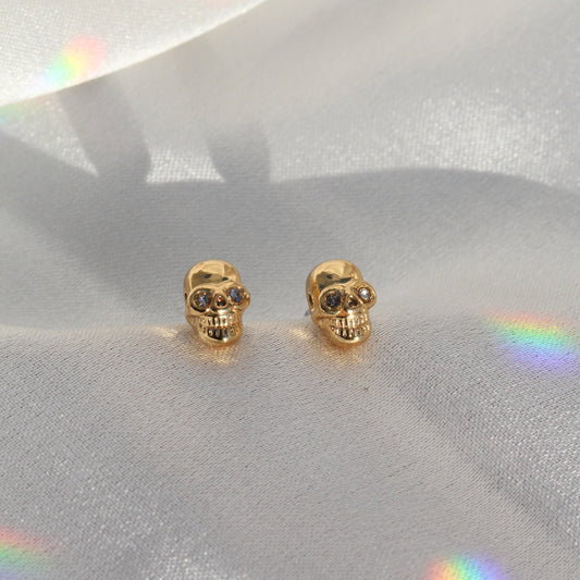 JW00438-GLD-OS-R - Tiny Skull Stud Earrings - Gold - Wildflower + Co. Jewelry Gifting satin