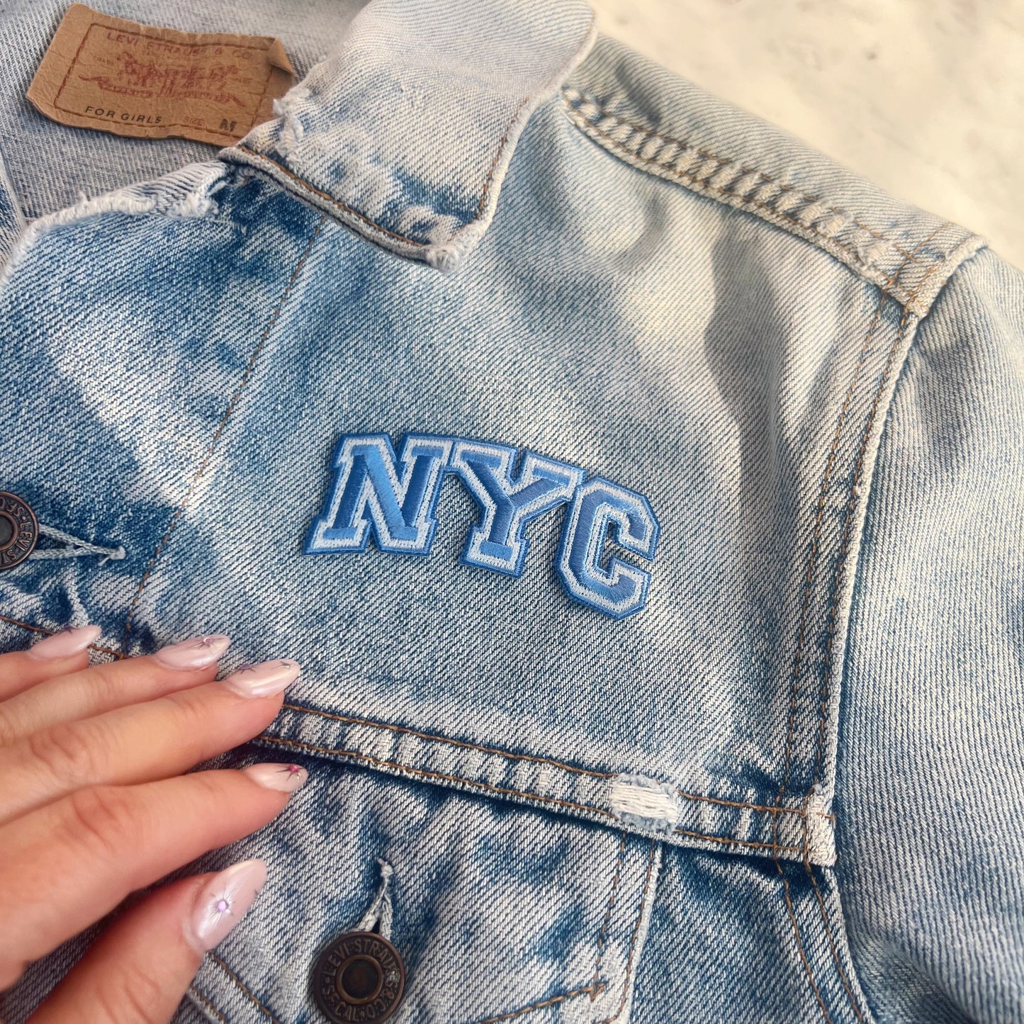 NYC Patch -Embroidered Iron On Patches for Jackets - New York City Souvenir - Wildflower + Co blue on jacket