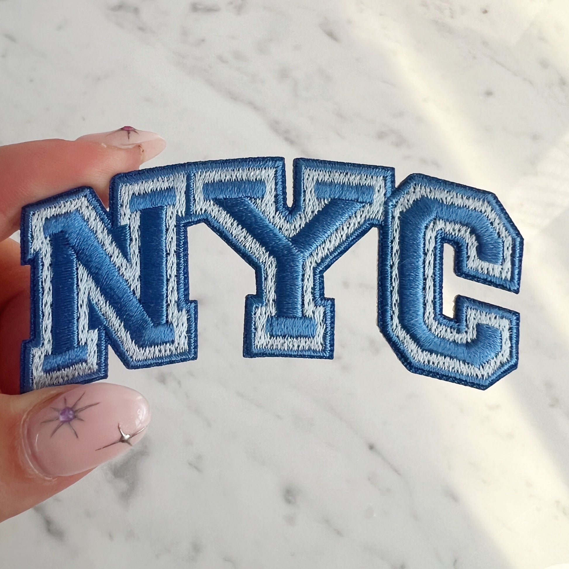 NYC Patch -Embroidered Iron On Patches for Jackets - New York City Souvenir - Wildflower + Co blue in hand