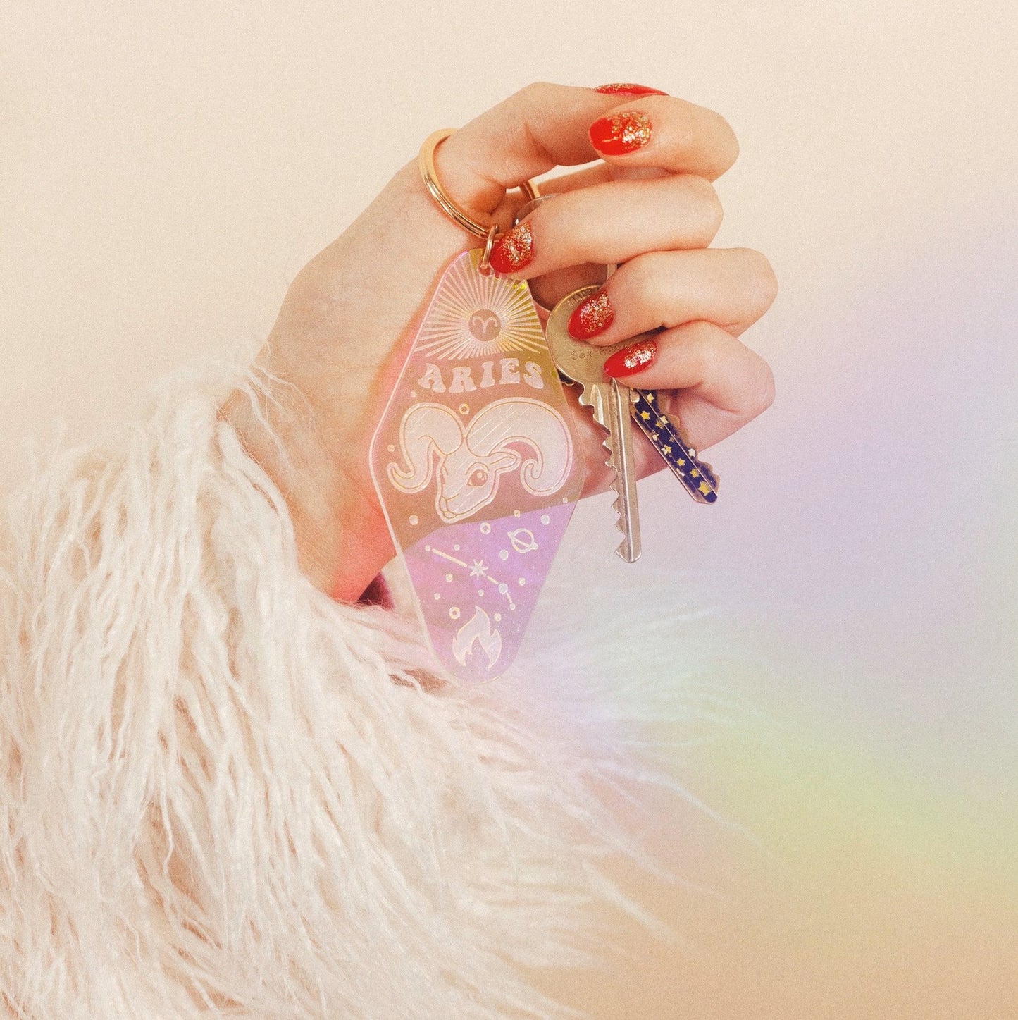 Zodiac Motel Keychains - Iridescent - Wildflower + Co. in hand w/ keys for scale
