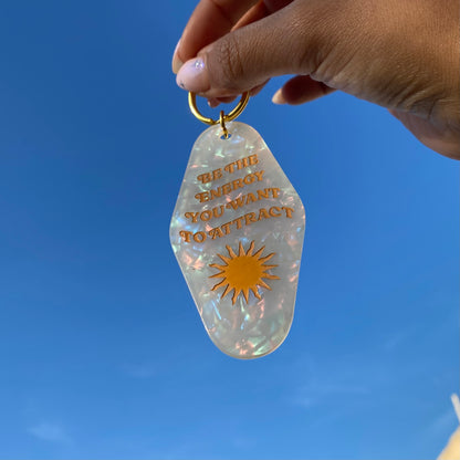 be the energy you want to attract motel keychain in hand
