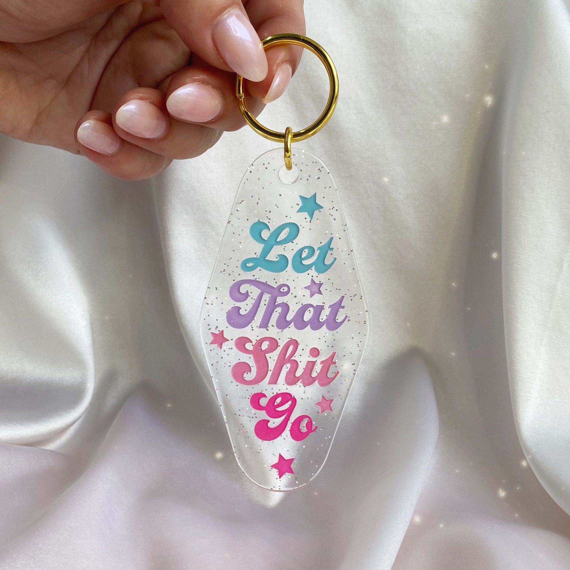 let that shit go glitter motel keychain in hand