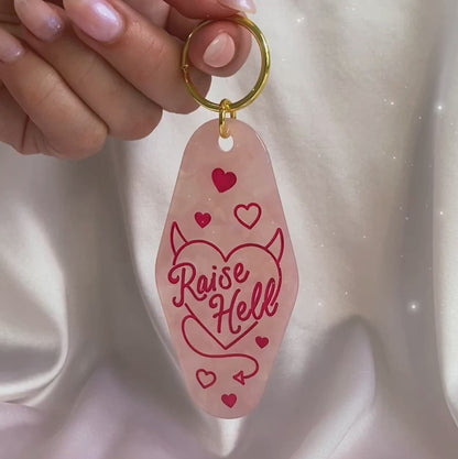 raise hell motel keychain - pink opalescent video in hand