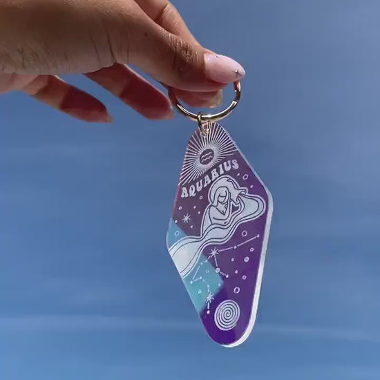 Zodiac Motel Keychains - Iridescent - Wildflower + Co. VIDEO against sky