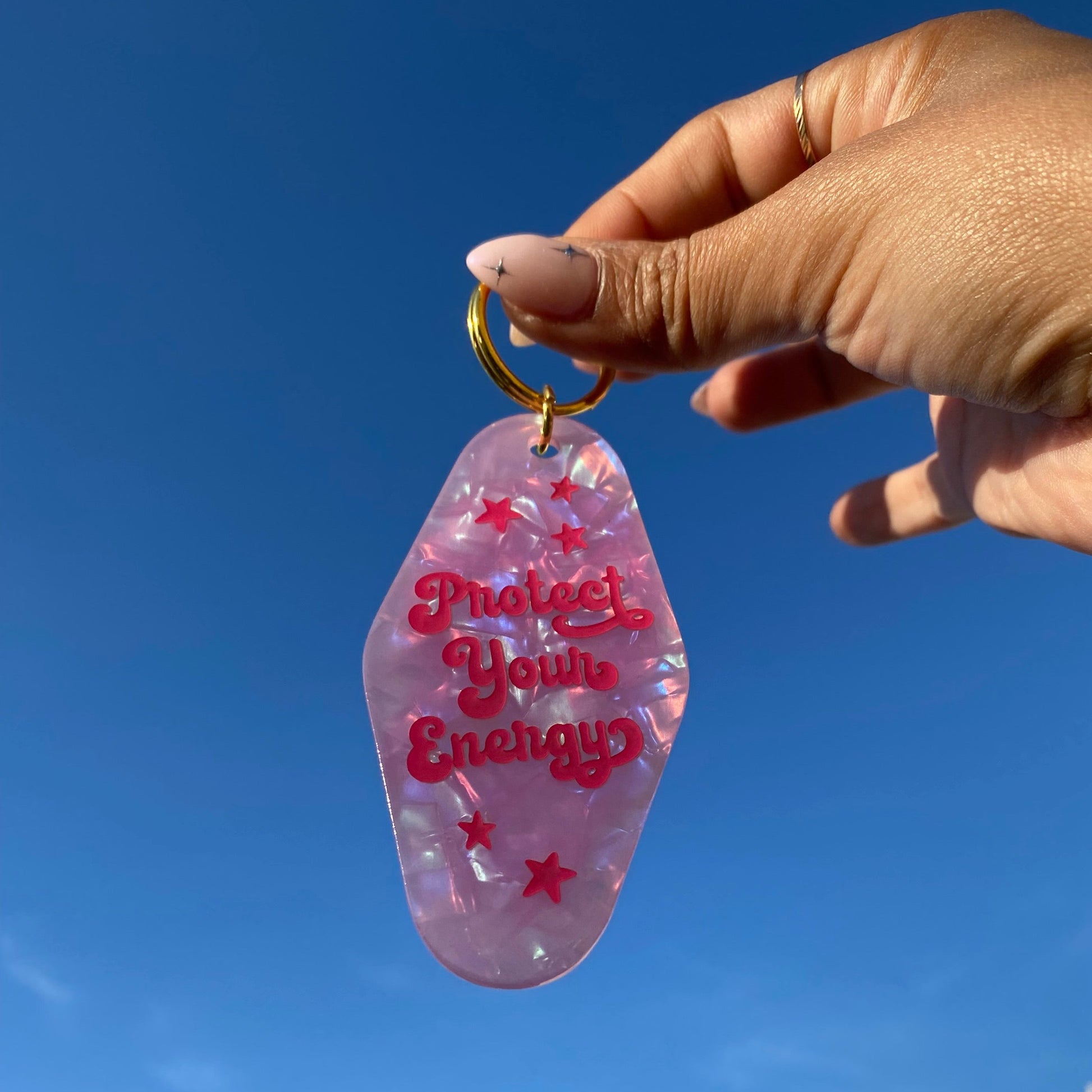 protect_your_energy_motel_keychain in hand
